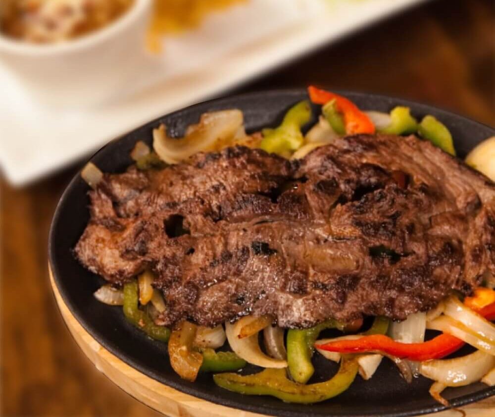 Grilled steak fajitas with onions and peppers