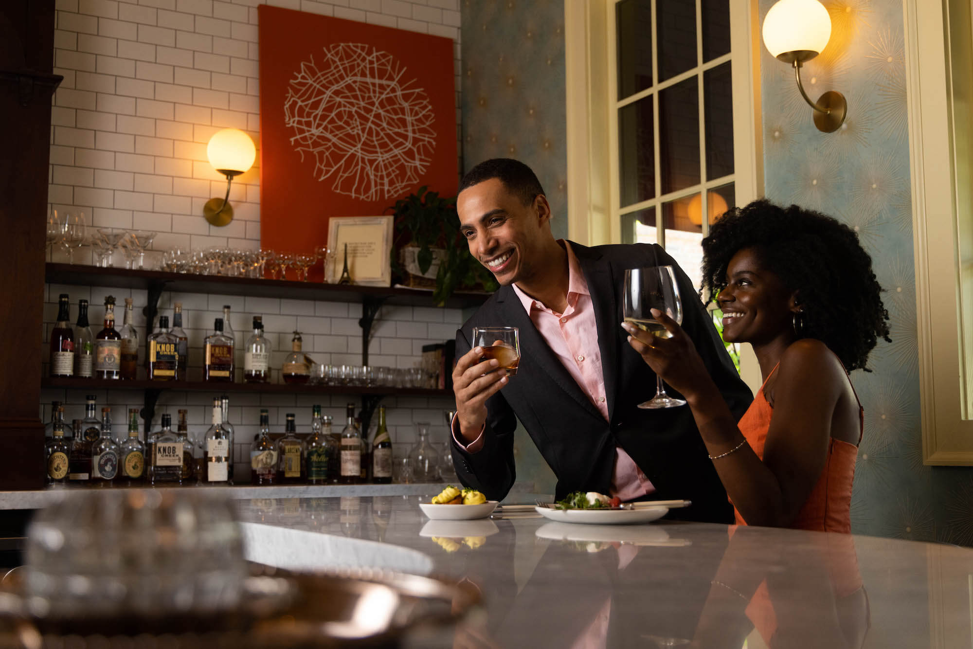 Couple enjoying cocktails at a bar