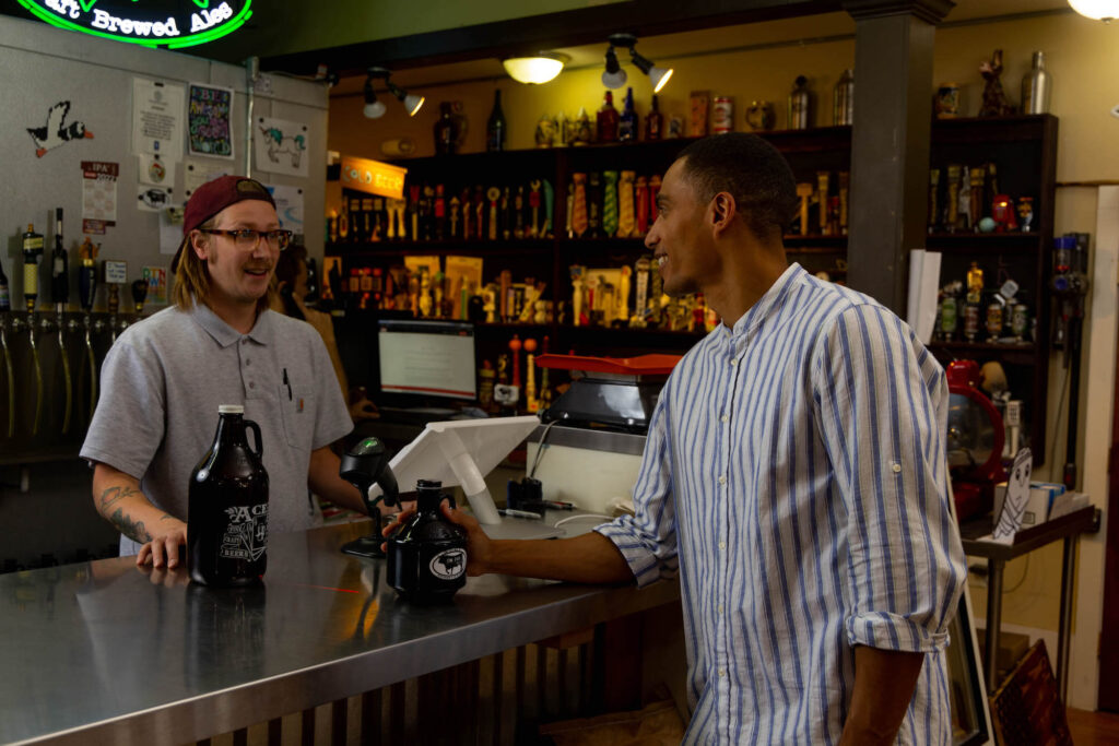 Man ordering beer growler