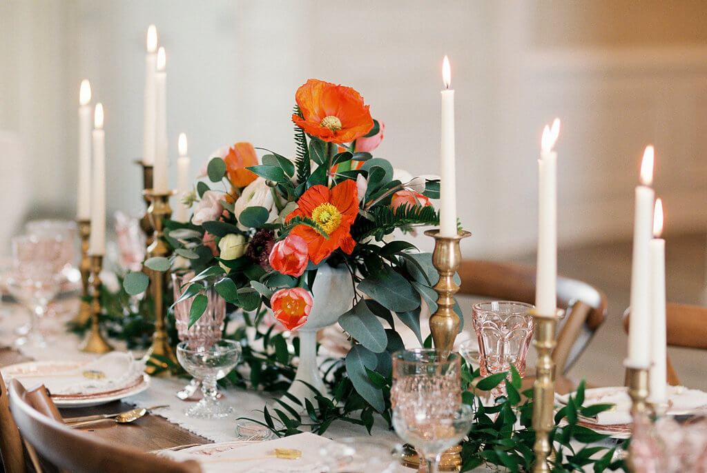 Beautiful table setting with red poppies and candles at The Venue at Murphy Lane