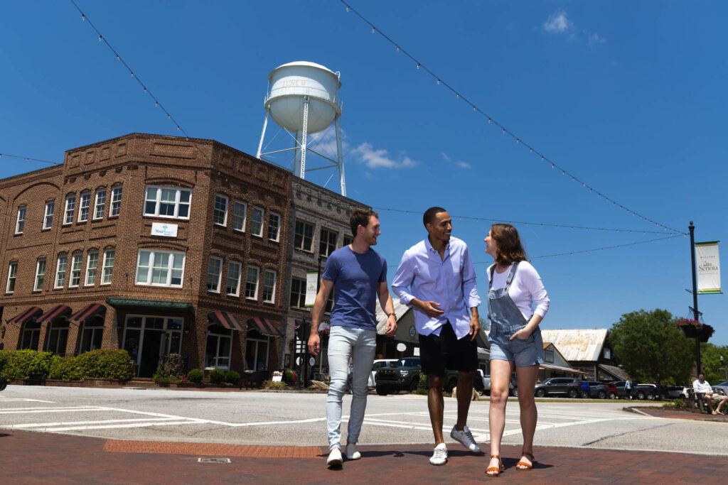 Three friends walking through Downtown Senoia