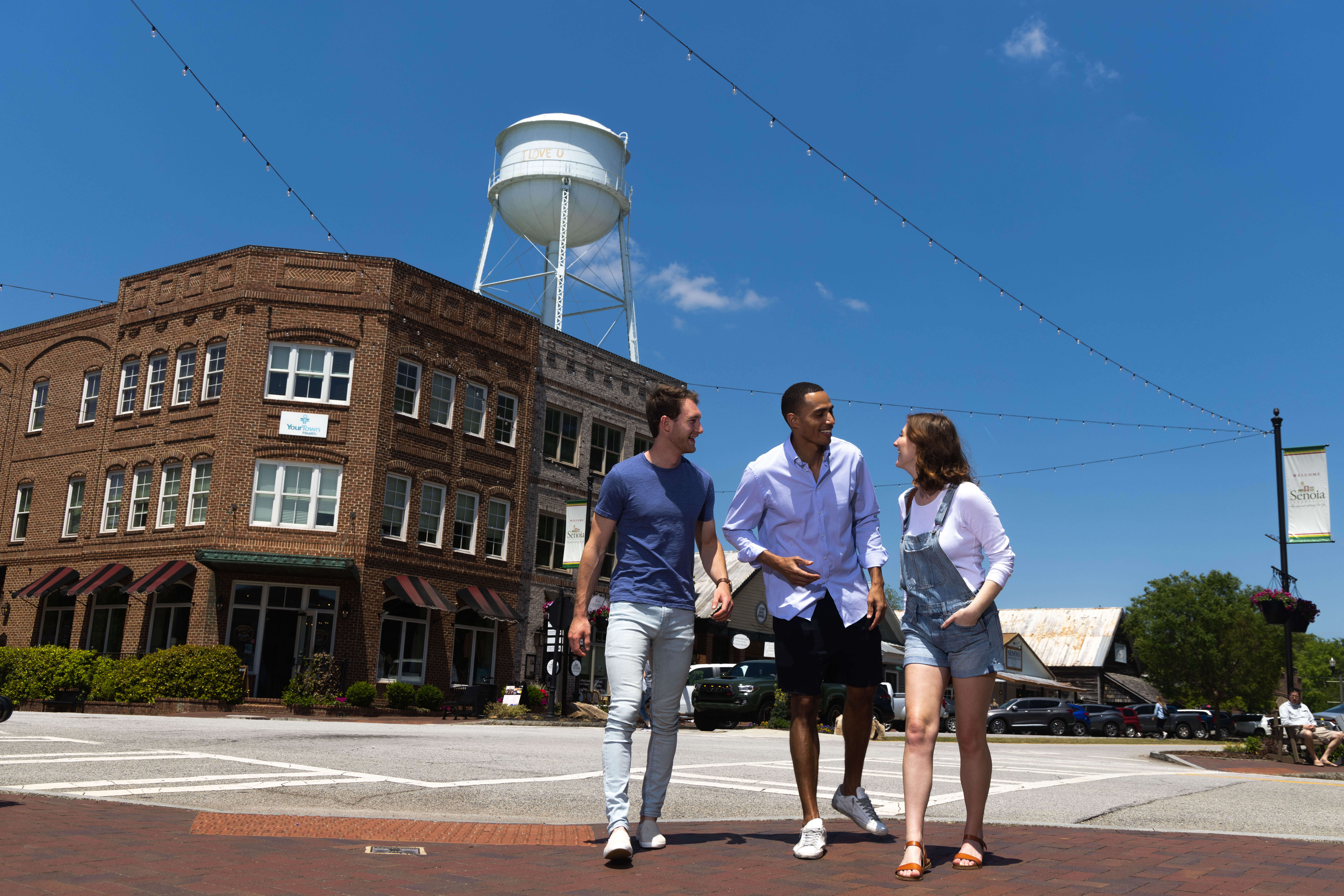 Three friends walking through historic downtown Senoia