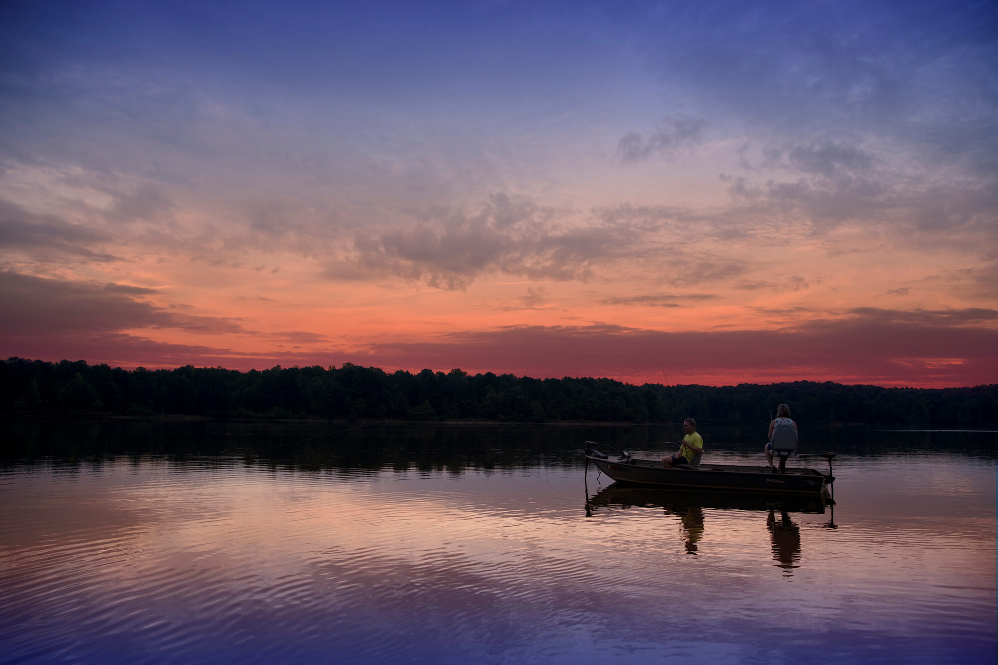 Single boat on a lake during sunset