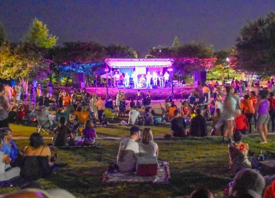Crowd of friends and family on a green at Jazz in the Park even