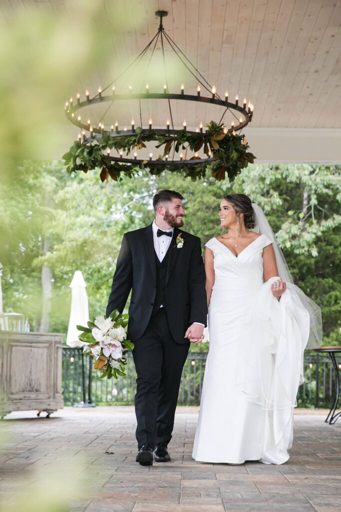 Happy bride and groom walking through The Venue at Murphy Lane