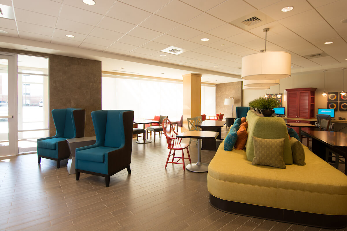 Modern lobby and breakfast area with seating at Home2Suites by Hilton