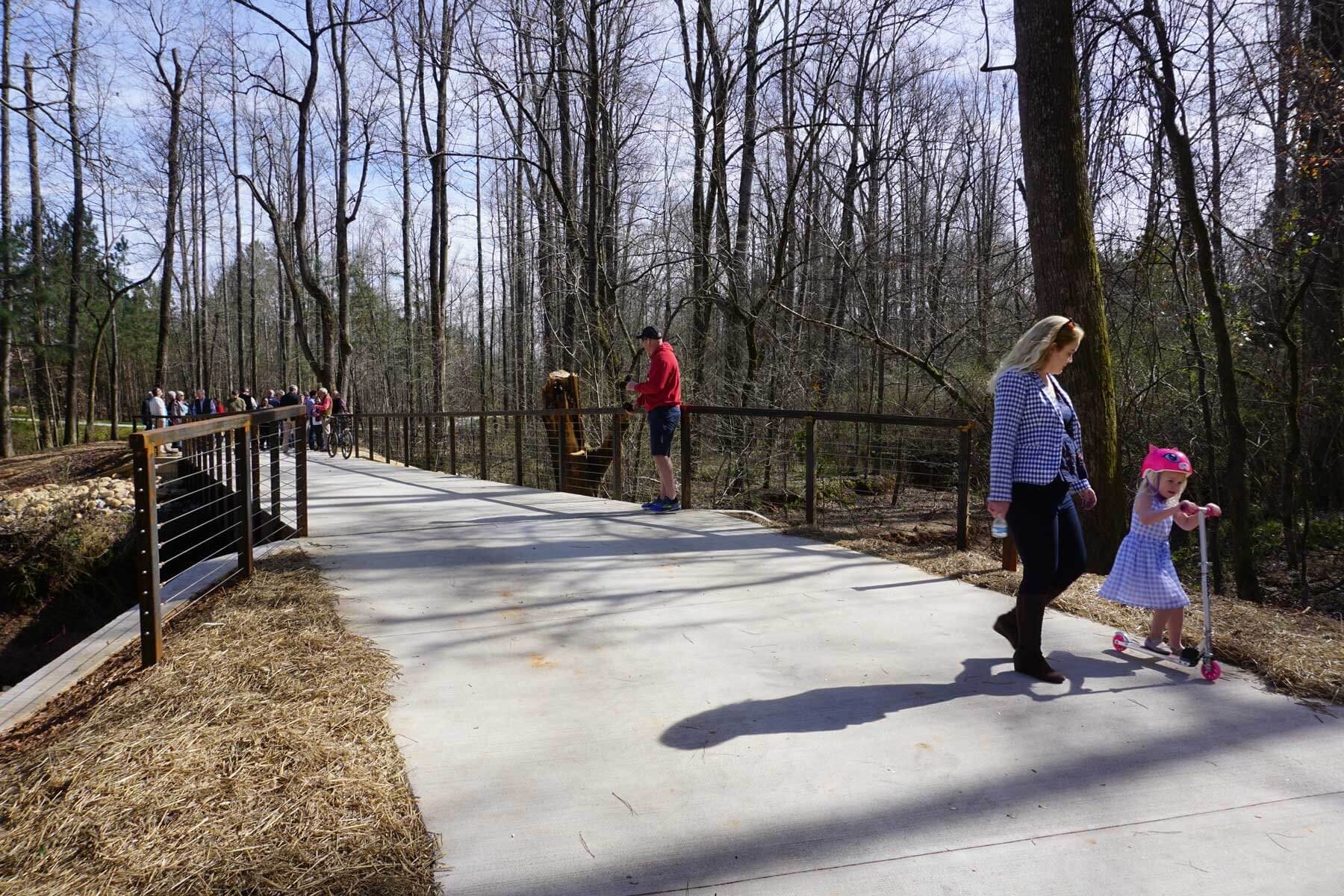 Families and friends enjoying The LINC on foot, bikes, and scooters